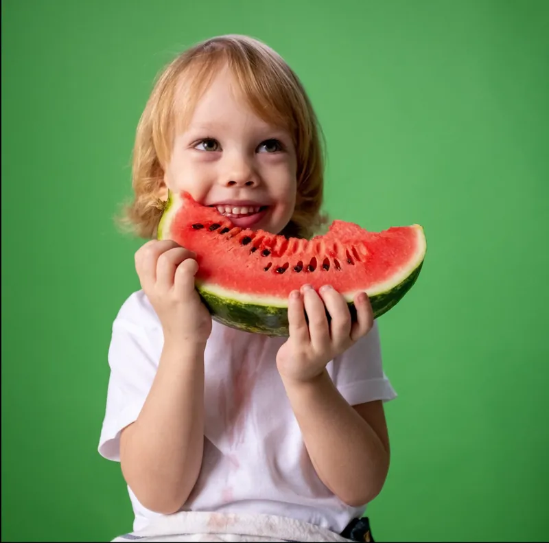 Child eating a slice of watermelon
